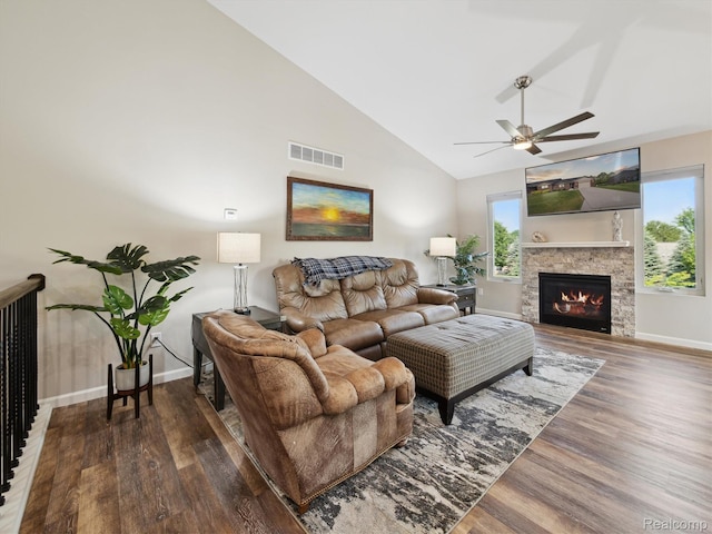 1470 Duncan Dr, Chelsea, MI 48118 - living area featuring wood finished floors, ceiling fan, a lit fireplace, and high vaulted ceiling