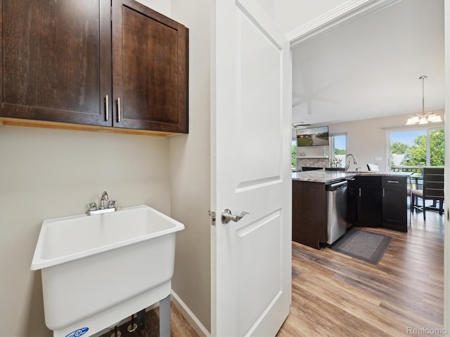 1470 Duncan Dr, Chelsea, MI 48118 - washroom with light wood-style floors and a chandelier