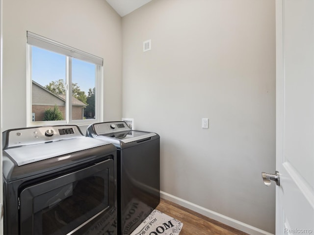 1470 Duncan Dr, Chelsea, MI 48118 - laundry room with washing machine and dryer and wood finished floors