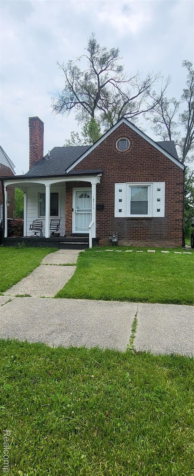 14750 Lannette St, Detroit, MI 48213 - view of front facade featuring a front lawn, a chimney, and brick siding