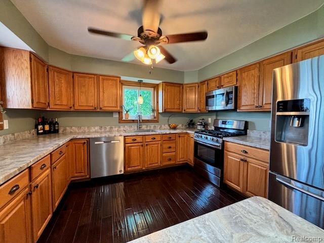 3985 Wadhams Rd, China, MI 48054 - kitchen with appliances with stainless steel finishes, a sink, a ceiling fan, light countertops, and dark wood finished floors