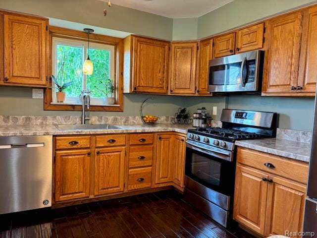 3985 Wadhams Rd, China, MI 48054 - kitchen featuring stainless steel appliances, a sink, light countertops, and brown cabinets