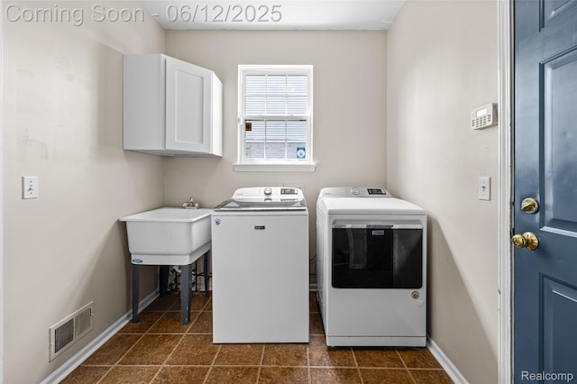 49620 Dunhill Dr, Macomb, MI 48044 - laundry area featuring washer and dryer, cabinet space, and dark tile patterned flooring