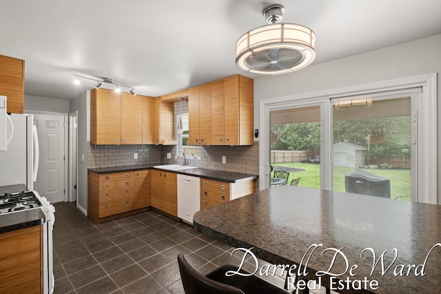 6662 Adaridge Dr SE, Ada, MI 49301 - kitchen featuring white appliances, dark countertops, dark tile patterned flooring, and tasteful backsplash