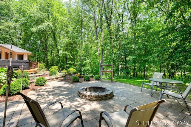 5151 Scotch Mist Dr, Saranac, MI 48881 - view of patio / terrace with an outdoor fire pit and a forest view