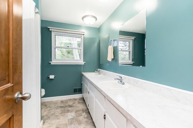 680 Eastlook Dr, Saline, MI 48176 - full bath with plenty of natural light, double vanity, and stone finish flooring