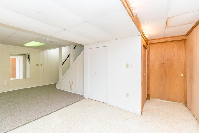 680 Eastlook Dr, Saline, MI 48176 - finished below grade area featuring a paneled ceiling, stairs, and a decorative wall