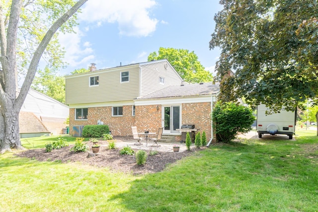 680 Eastlook Dr, Saline, MI 48176 - rear view of house featuring brick siding, a patio, and a lawn