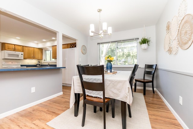 680 Eastlook Dr, Saline, MI 48176 - dining area featuring a chandelier, light wood-style floors, and recessed lighting