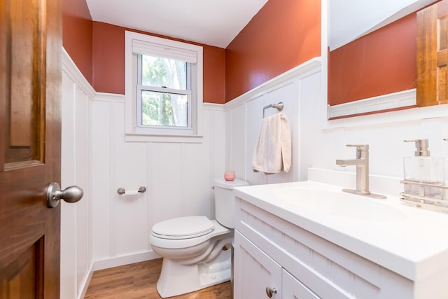 680 Eastlook Dr, Saline, MI 48176 - half bathroom featuring vanity, a decorative wall, wood finished floors, and a wainscoted wall