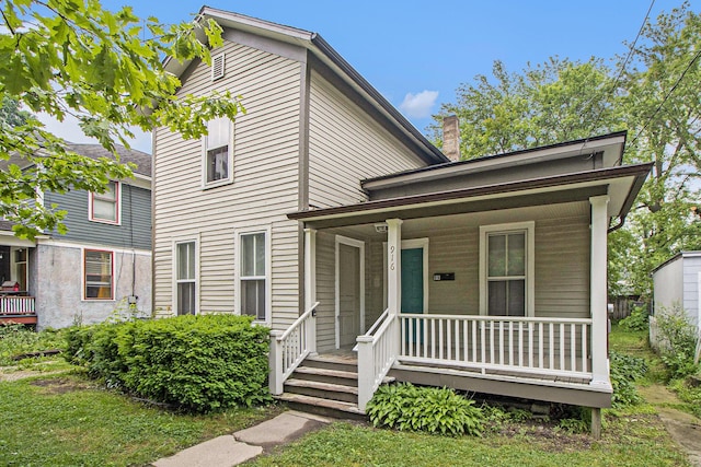 916 Osborne St, Kalamazoo, MI 49001 - view of front of house with covered porch and a chimney