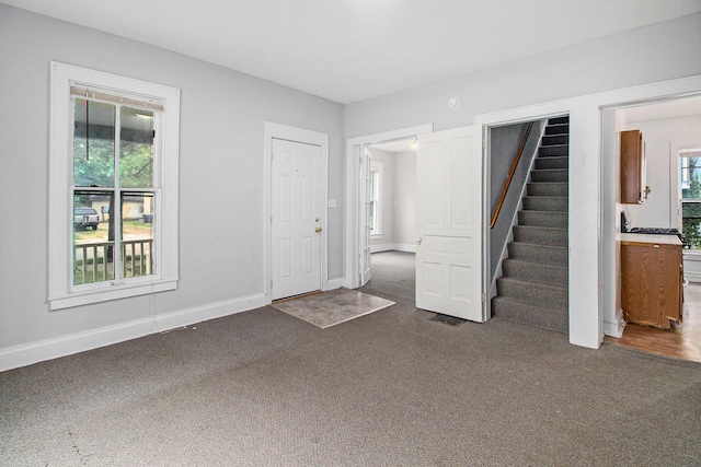 916 Osborne St, Kalamazoo, MI 49001 - unfurnished living room featuring carpet floors and stairs