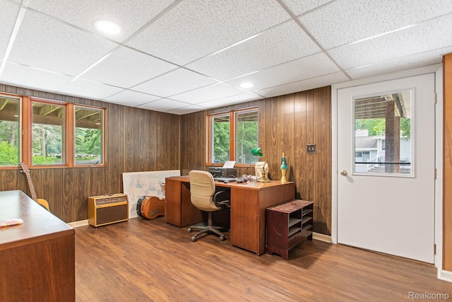 199 Grand Ave, Grand Haven, MI 49417 - office space with a paneled ceiling, healthy amount of natural light, wood finished floors, and wooden walls