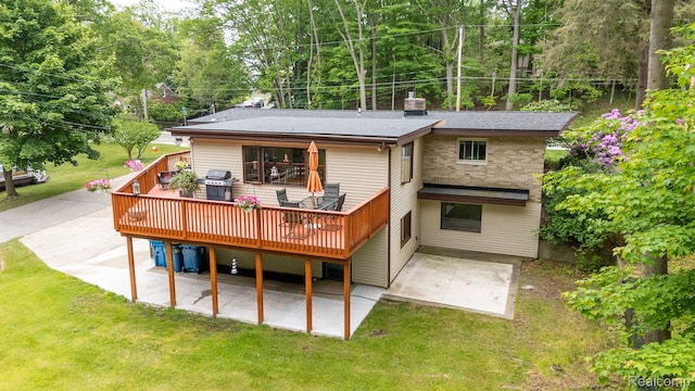199 Grand Ave, Grand Haven, MI 49417 - rear view of house featuring a patio area, a yard, and a wooden deck