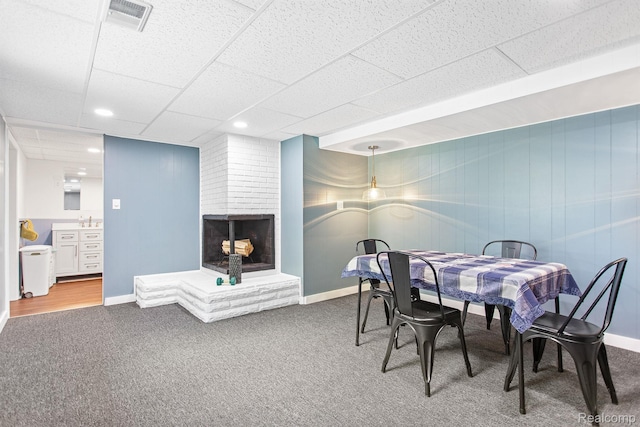 199 Grand Ave, Grand Haven, MI 49417 - carpeted dining space featuring a brick fireplace, a drop ceiling, and recessed lighting