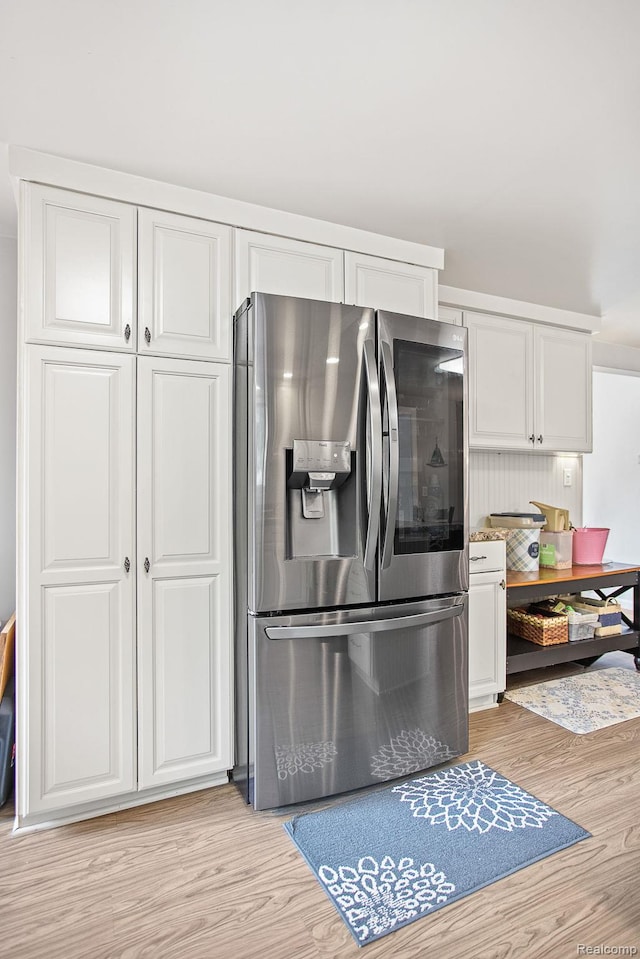 199 Grand Ave, Grand Haven, MI 49417 - kitchen with stainless steel fridge with ice dispenser, light wood-style floors, and white cabinetry