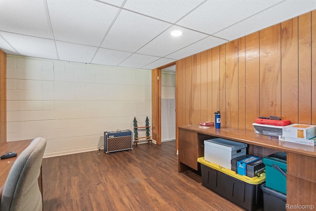 199 Grand Ave, Grand Haven, MI 49417 - home office featuring a drop ceiling, concrete block wall, and dark wood-type flooring