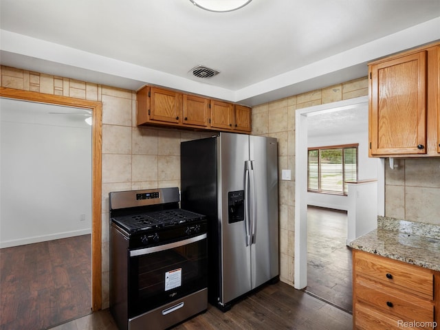 23400 Marlow St, Oak Park, MI 48237 - kitchen with stainless steel appliances, dark wood finished floors, brown cabinetry, and tasteful backsplash