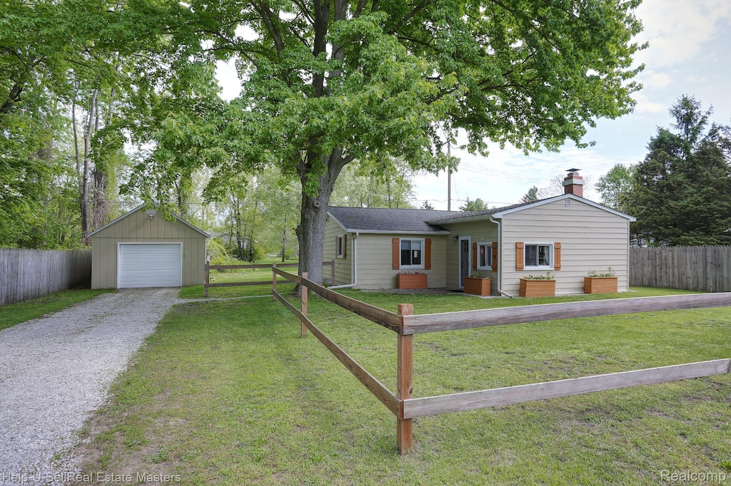 3820 Pine Rd, Burtchville, MI 48059 - ranch-style home with driveway, an outbuilding, a detached garage, and a chimney