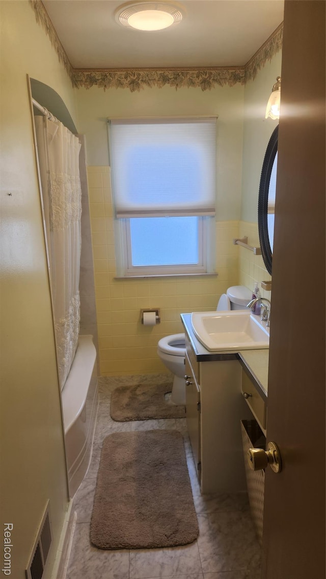 3335 Linden St, Dearborn, MI 48124 - full bath featuring vanity, tile walls, tile patterned flooring, wainscoting, and shower / bathtub combination with curtain