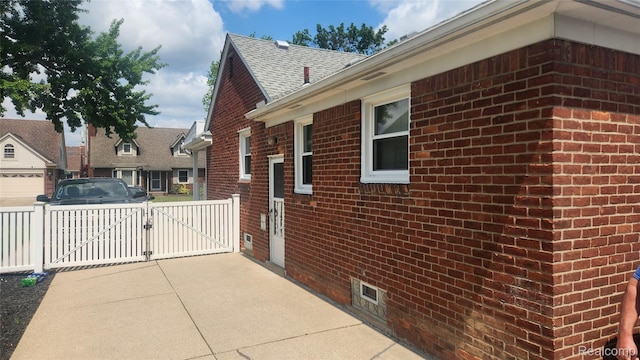 3335 Linden St, Dearborn, MI 48124 - view of side of home featuring a gate, brick siding, and a shingled roof