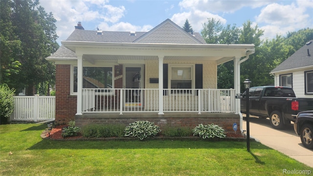 3335 Linden St, Dearborn, MI 48124 - view of front of home with covered porch, a chimney, and a shingled roof