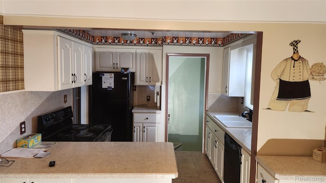 3335 Linden St, Dearborn, MI 48124 - kitchen with black appliances, backsplash, light countertops, white cabinetry, and dark tile patterned flooring