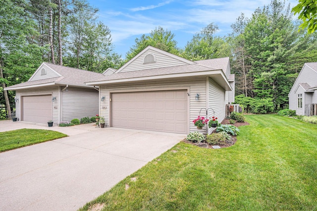 541 Tournament Cir Unit 14, Norton Shores, MI 49444 - single story home with roof with shingles, driveway, an attached garage, and a front lawn