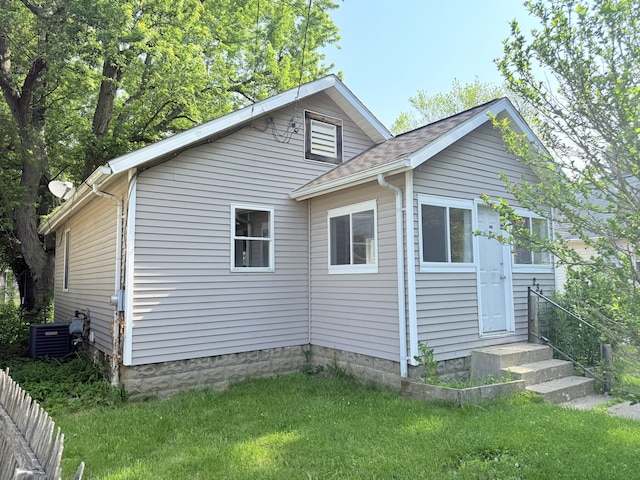 234 Broad St, Michigan Center, MI 49254 - view of side of home featuring a lawn, entry steps, and roof with shingles