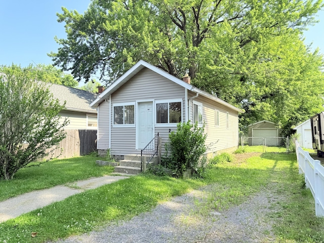 234 Broad St, Michigan Center, MI 49254 - view of front of house with entry steps, a chimney, and an outdoor structure