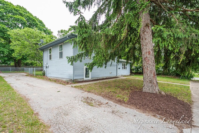 348 Yuba St, Muskegon, MI 49442 - view of side of property with asphalt driveway