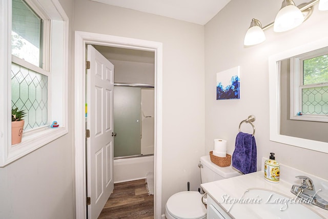 348 Yuba St, Muskegon, MI 49442 - bathroom with vanity, bath / shower combo with glass door, and wood finished floors