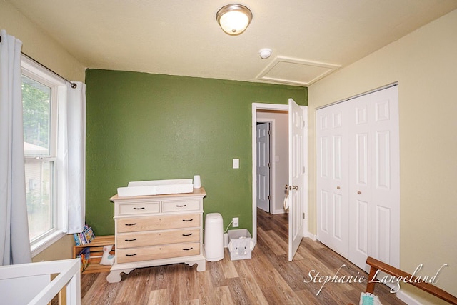 348 Yuba St, Muskegon, MI 49442 - bedroom with wood finished floors, a closet, and attic access