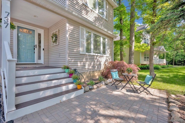 737 Camilla Blvd, Lake Orion, MI 48362 - view of exterior entry with a patio area and a yard