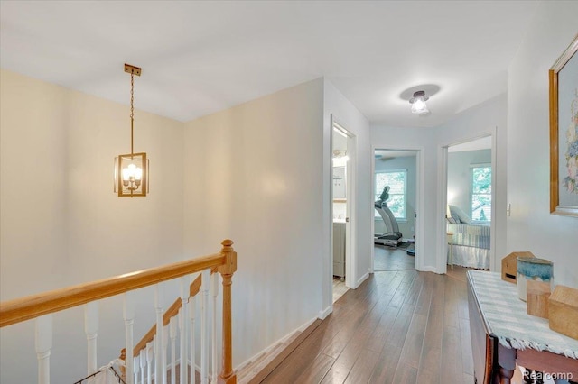 737 Camilla Blvd, Lake Orion, MI 48362 - corridor featuring an upstairs landing, wood finished floors, and a chandelier