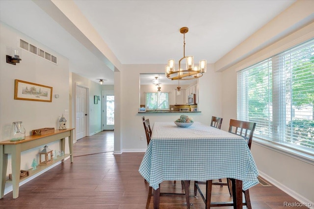 737 Camilla Blvd, Lake Orion, MI 48362 - dining area with plenty of natural light, a chandelier, and dark wood finished floors