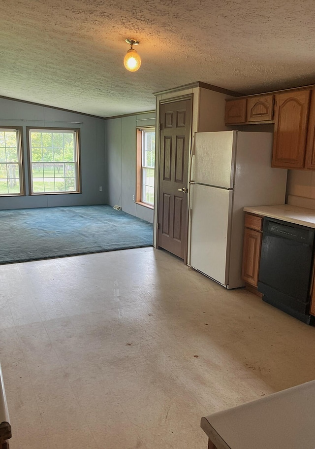 7560 W Washington Rd, Sumner, MI 48889 - kitchen with dishwasher, a textured ceiling, healthy amount of natural light, freestanding refrigerator, and light countertops