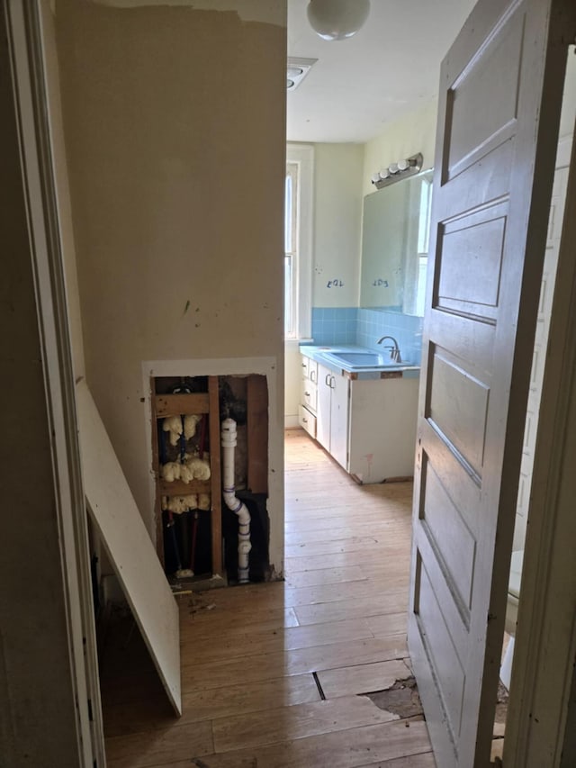 1111 E Michigan Ave, Albion, MI 49224 - hallway featuring a sink and light wood-style floors