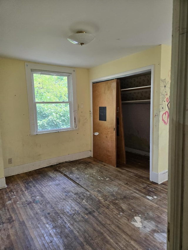 1111 E Michigan Ave, Albion, MI 49224 - unfurnished bedroom featuring wood finished floors and a closet
