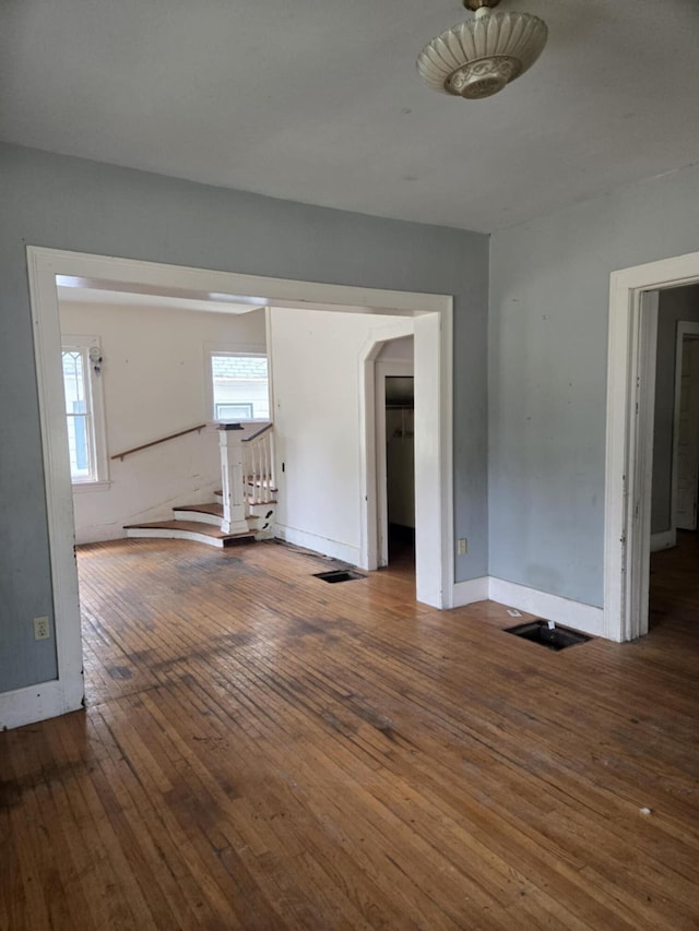 1111 E Michigan Ave, Albion, MI 49224 - spare room featuring hardwood / wood-style flooring and stairway