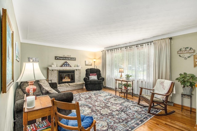 6361 Plainfield Ave, Kalamazoo, MI 49048 - living room featuring a brick fireplace and wood finished floors