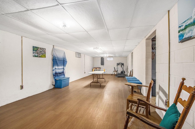 6361 Plainfield Ave, Kalamazoo, MI 49048 - recreation room featuring wood finished floors, a paneled ceiling, and concrete block wall