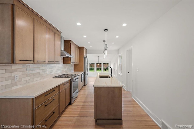 15589 Kirkshire Ave, Beverly Hills, MI 48025 - kitchen with stainless steel appliances, wall chimney range hood, tasteful backsplash, an island with sink, and recessed lighting