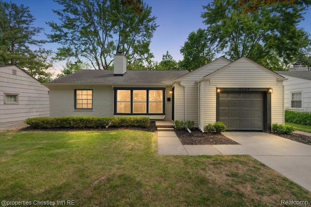 15589 Kirkshire Ave, Beverly Hills, MI 48025 - view of front facade with concrete driveway, a garage, a front lawn, and a chimney