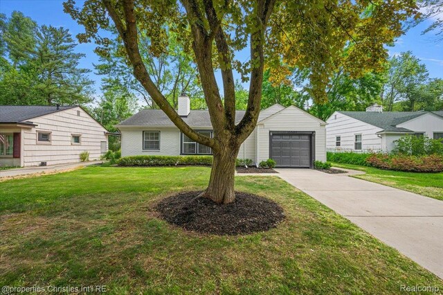 15589 Kirkshire Ave, Beverly Hills, MI 48025 - view of front of property with a garage, a chimney, driveway, and a front yard