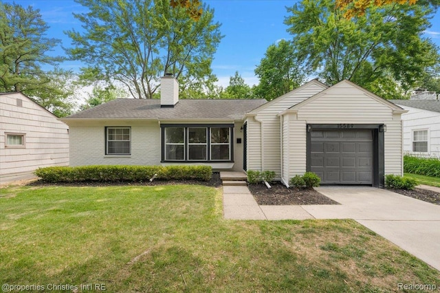15589 Kirkshire Ave, Beverly Hills, MI 48025 - view of front of house with an attached garage, driveway, a front yard, and a chimney