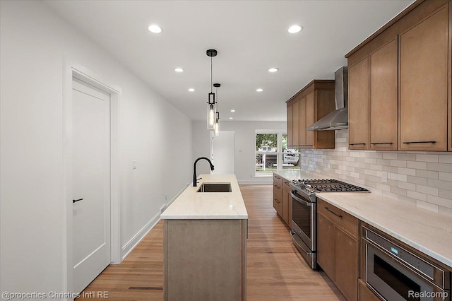 15589 Kirkshire Ave, Beverly Hills, MI 48025 - kitchen featuring wall chimney exhaust hood, appliances with stainless steel finishes, recessed lighting, a kitchen island with sink, and light wood finished floors