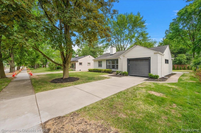 15589 Kirkshire Ave, Beverly Hills, MI 48025 - view of front of home featuring a garage, a chimney, a front yard, and concrete driveway