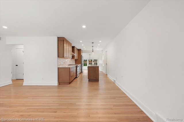 15589 Kirkshire Ave, Beverly Hills, MI 48025 - kitchen with gas stove, recessed lighting, light wood-style floors, brown cabinets, and hanging light fixtures