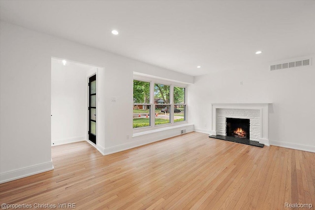 15589 Kirkshire Ave, Beverly Hills, MI 48025 - unfurnished living room featuring light wood finished floors, a lit fireplace, and recessed lighting